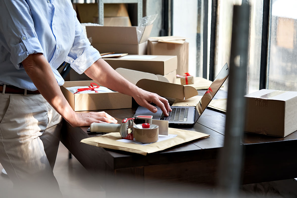 woman packing orders for small business